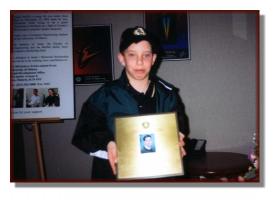 Mike Moffitt holding his brother Andy's plaque